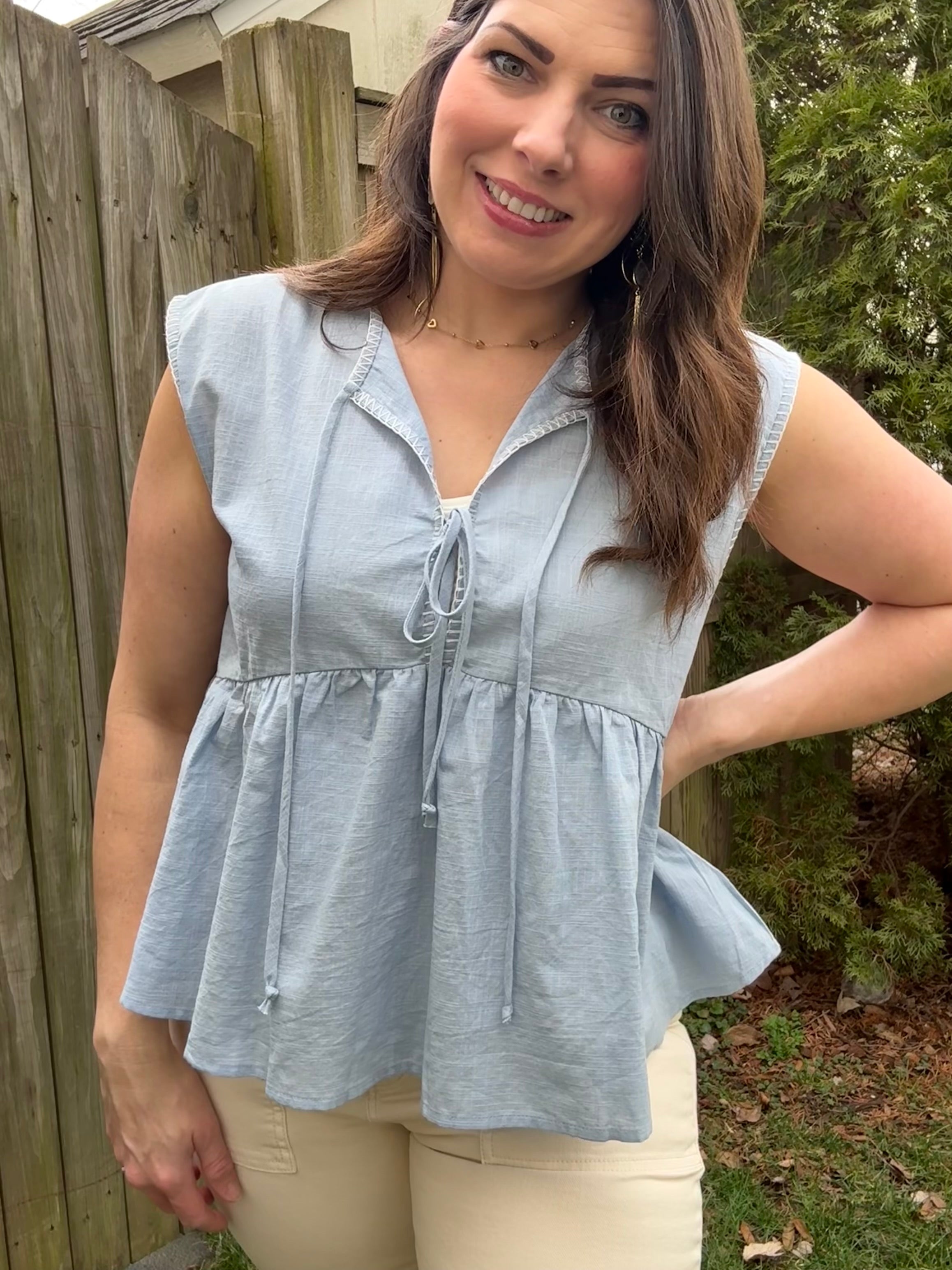 Model wearing blue flowy tied up top, 100% cotton lightweight fabric 