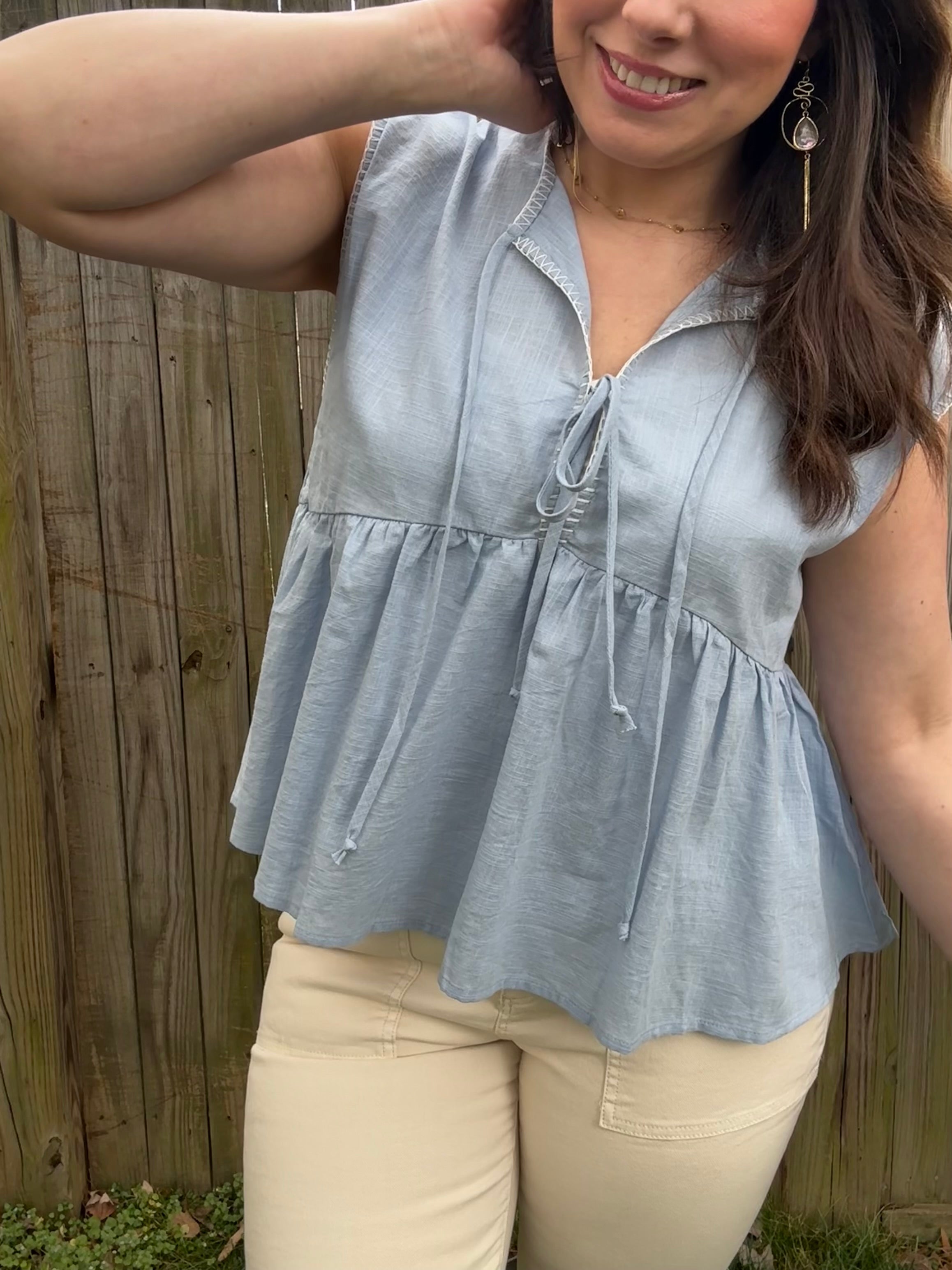 Model wearing blue flowy tied up top, 100% cotton lightweight fabric 