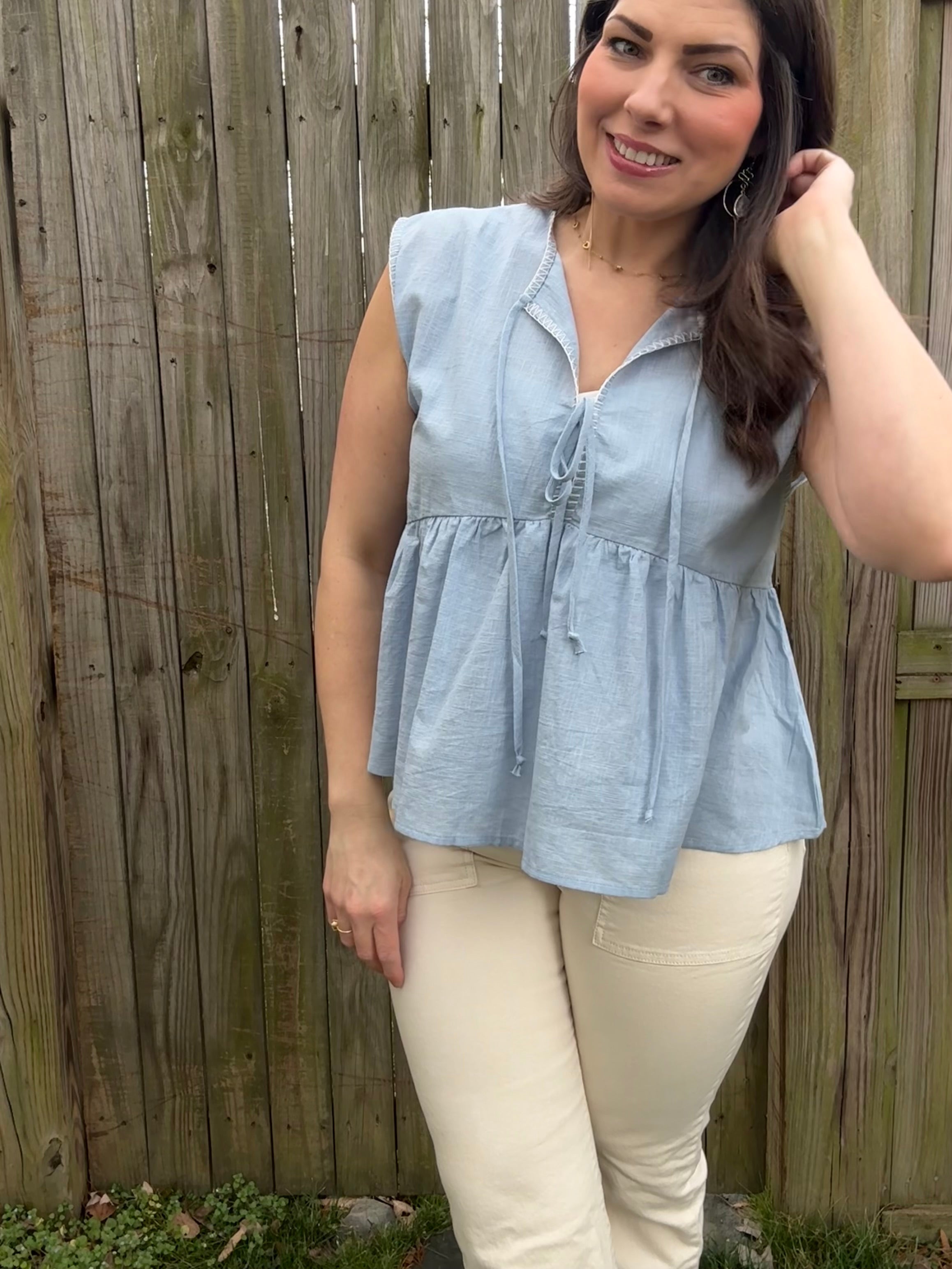 Model wearing blue flowy tied up top, 100% cotton lightweight fabric 