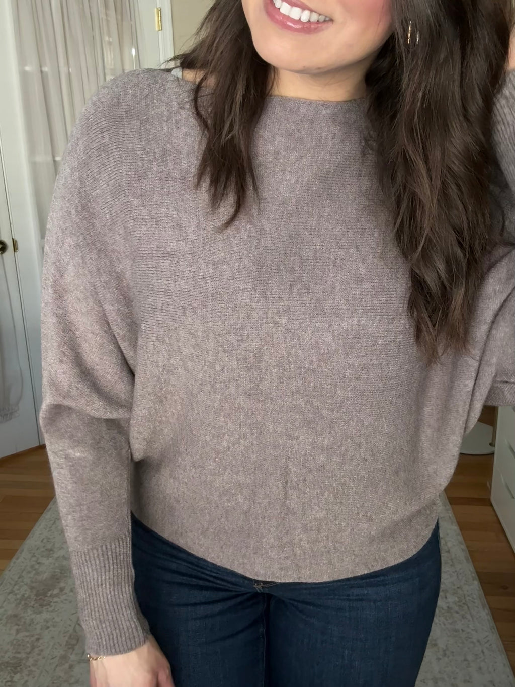 Woman wearing soft wool blend taupe boatneck sweater that is made in Italy 
