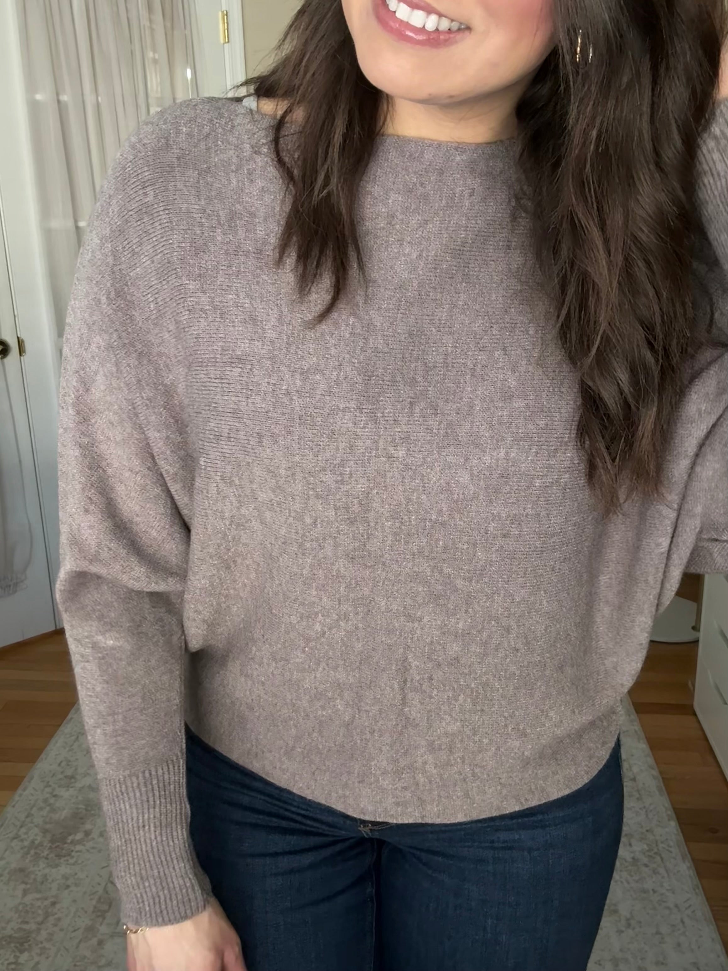 Woman wearing soft wool blend taupe boatneck sweater that is made in Italy 