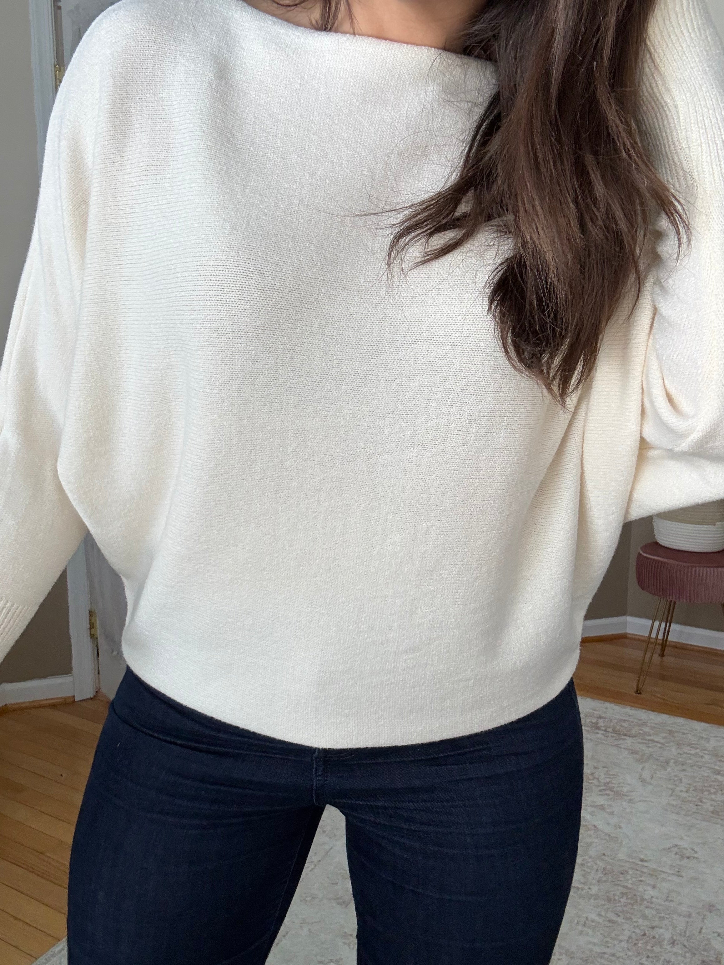 Woman wearing soft wool blend cream boatneck sweater that is made in Italy 