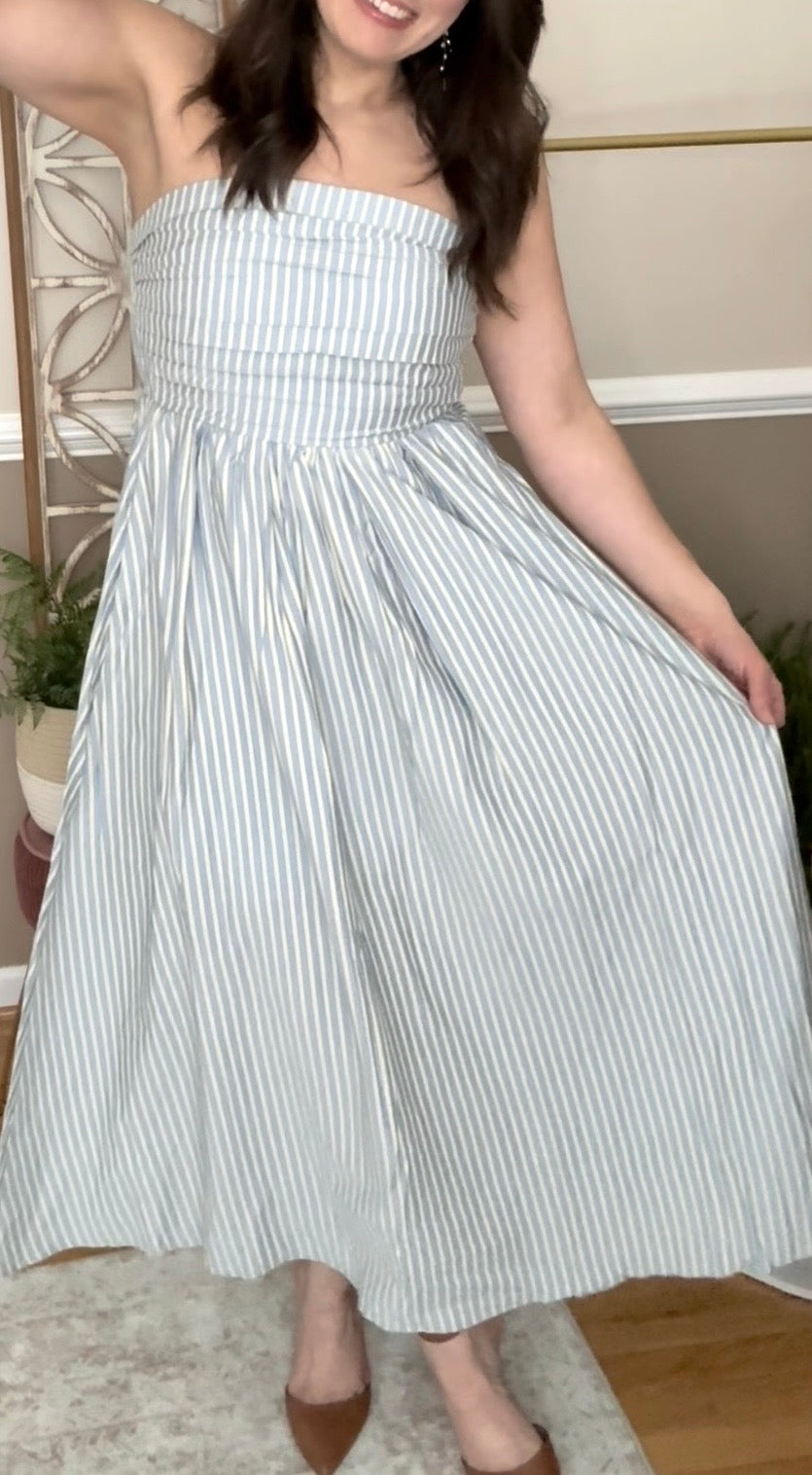 Model wearing a strapless blue and yellow flowy dress, perfect spring and summer dress
